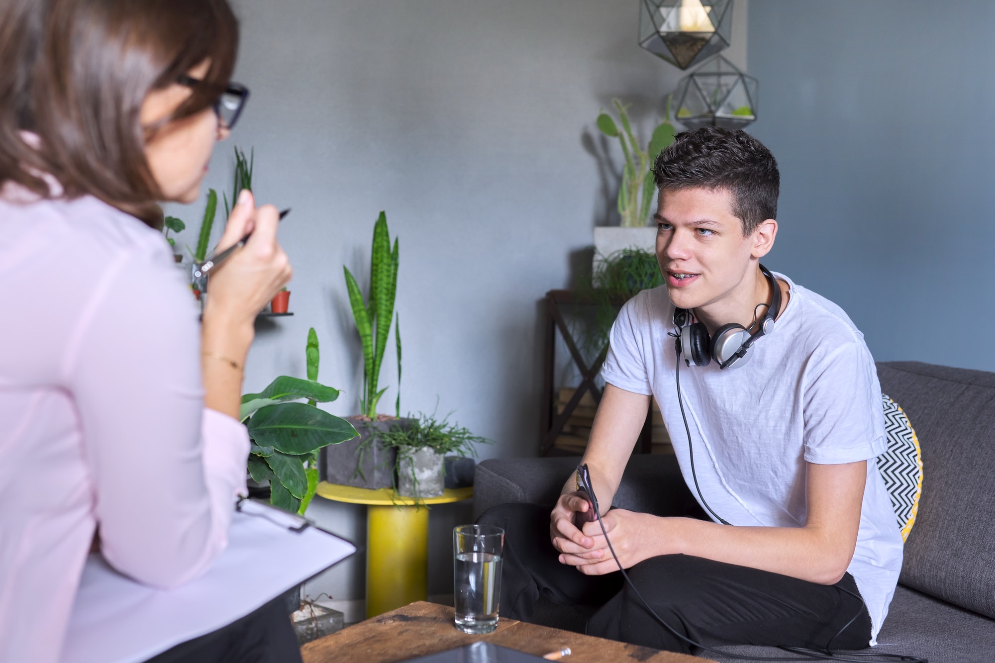 Teenage boy at meeting with female professional doctor psychologist